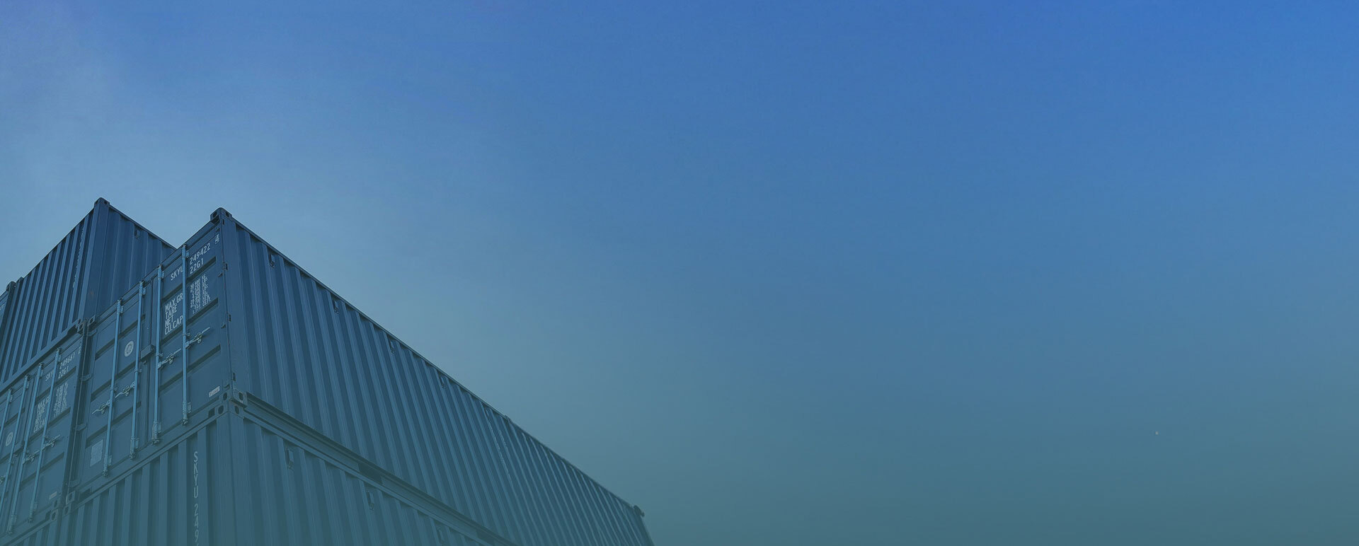 Artistic image of a shipping container and the clear sky above it