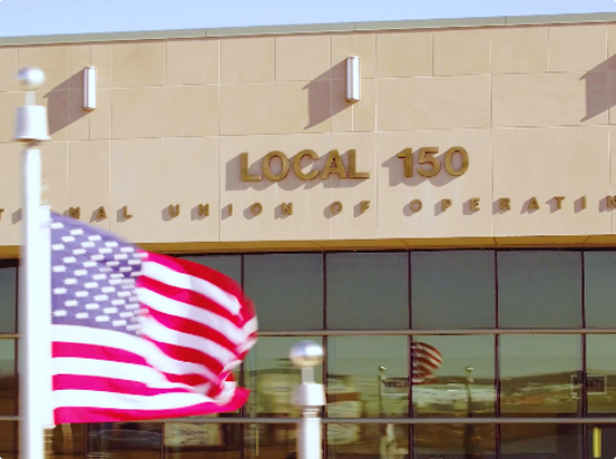 Exterior photo of the American Flag and Local 150 Office sign