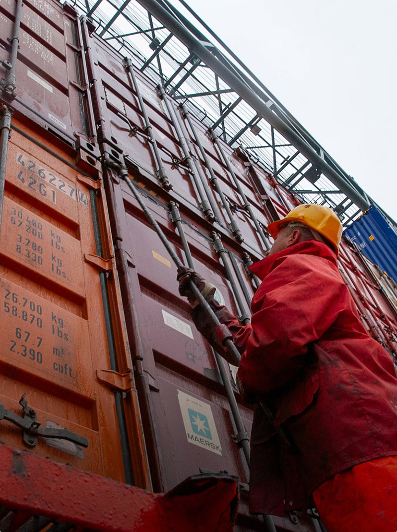 A rail worker in the Union Pacific Joliet Intermodal Terminal checking on a container